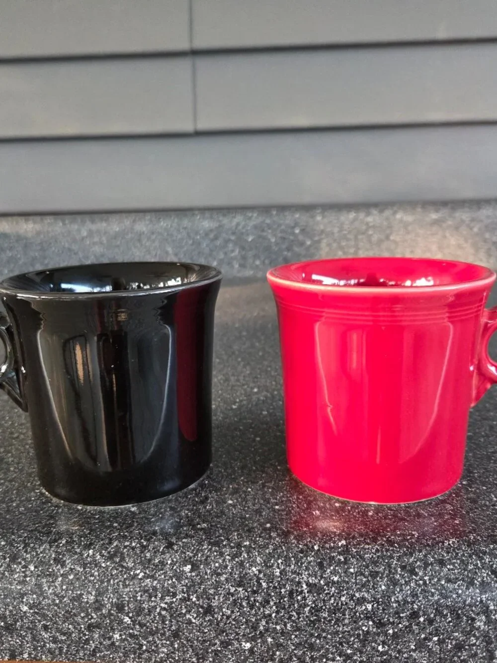 Fiestaware ceramic mugs in black and red with a ring handle, 10.25 oz capacity.